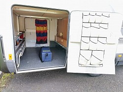 Rear right garage access door with wheel ramps in case.