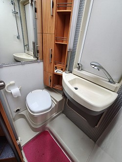 Bathroom. Sink rotates away from wall to give space for shower.